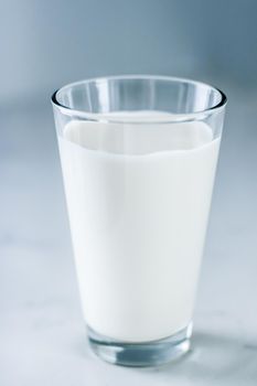 Dairy, healthy nutrition and breakfast concept - World Milk Day, full glass on marble table