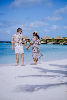 Aruba March 2021 beach with pink flamingos at the beach, Aruba , couple of men and woman on luxury vacation men and woman on honeymoon at the beach Aruba