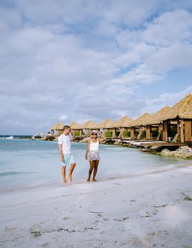 Aruba March 2021 beach with pink flamingos at the beach, Aruba , couple of men and woman on luxury vacation men and woman on honeymoon at the beach Aruba