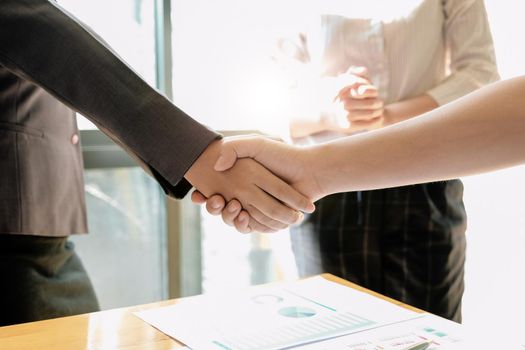 Business people shaking hands, finishing up meeting, business etiquette, congratulation, merger and acquisition concept.