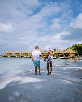 Aruba March 2021 beach with pink flamingos at the beach, Aruba , couple of men and woman on luxury vacation men and woman on honeymoon at the beach Aruba