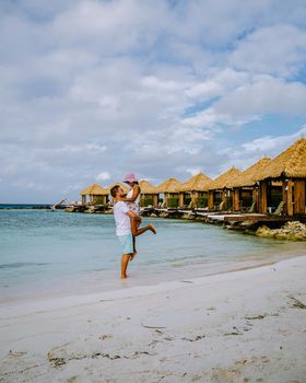 Aruba March 2021 beach with pink flamingos at the beach, Aruba , couple of men and woman on luxury vacation men and woman on honeymoon at the beach Aruba