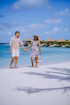 Aruba March 2021 beach with pink flamingos at the beach, Aruba , couple of men and woman on luxury vacation men and woman on honeymoon at the beach Aruba