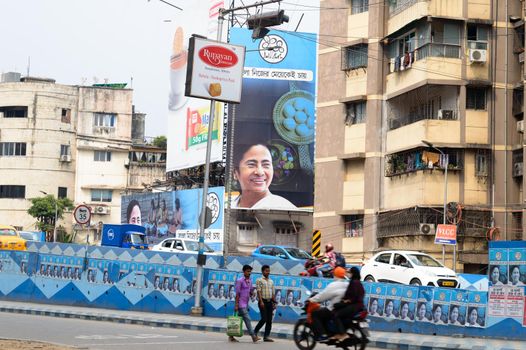 Political hoarding of Mamata Banerjee Trinamool Congress supreme showing Bangla Nijer Meye kei Chay (Bengal wants its own daughter ) in city street of Kolkata West Bengal India 17 April 2021