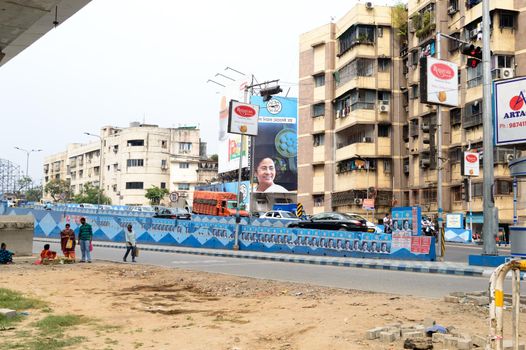 Political hoarding of Mamata Banerjee Trinamool Congress supreme showing Bangla Nijer Meye kei Chay (Bengal wants its own daughter ) in city street of Kolkata West Bengal India 17 April 2021