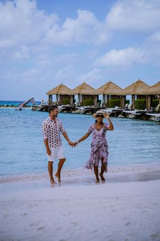 Aruba March 2021 beach with pink flamingos at the beach, Aruba , couple of men and woman on luxury vacation men and woman on honeymoon at the beach Aruba