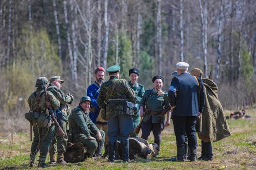 Reconstruction of the Second World War. The soldiers are standing in groups, talking. The Great Patriotic War. Liberation of Odessa. Zelenograd Russia April 18, 2021