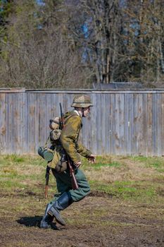 Reconstruction of the Second World War. A German soldier is running. The Great Patriotic War. Liberation of Odessa. Zelenograd Russia April 18, 2021