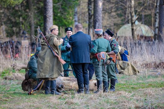 Reconstruction of the Second World War. The soldiers are standing in groups, talking. The Great Patriotic War. Liberation of Odessa. Zelenograd Russia April 18, 2021