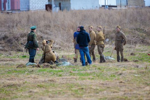 Reconstruction of the Second World War. The soldiers are standing in groups, talking. The Great Patriotic War. Liberation of Odessa. Zelenograd Russia April 18, 2021