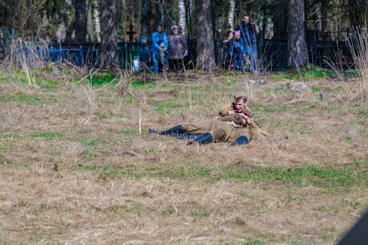 Reconstruction of the Second World War. Wounded soldiers lie on the battlefield. The Great Patriotic War. Liberation of Odessa. Zelenograd Russia April 18, 2021