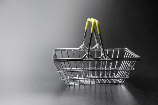 steel supermarket basket on black background close-up. High quality photo