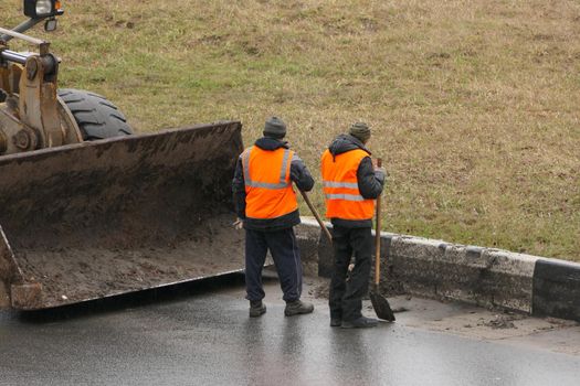 It's a clean city. People, workers clean the roads. Roadworks and road cleaning. High quality photo