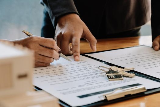 Real estate agent offer hand for customer sign agreement contract signature for buy or sell house. Real estate concept contact agreement concept.