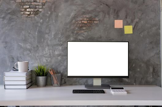 Mock up : Stylish or designer workspace with desktop computer, creative supplies, houseplant and vintage books on white work table at home or studio. Blank screen for graphics display montage.