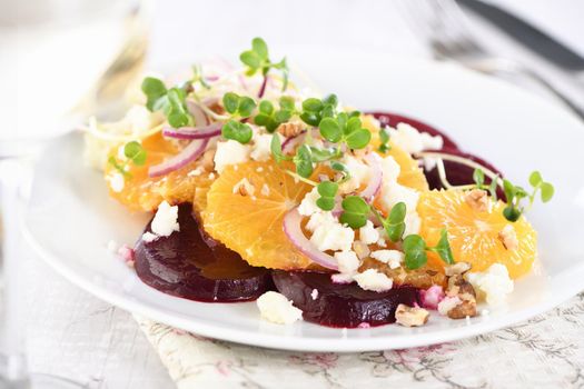 Orange salad with baked beetroot, goat cheese, microgreens and nuts. Perfect as a side dish or as a light lunch for a brunch or dinner.