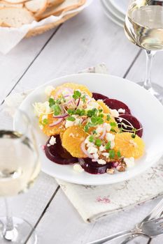 Orange salad with baked beetroot, goat cheese, microgreens and nuts. Perfect as a side dish or as a light lunch for a brunch or dinner.