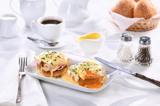 Breakfast. Best Eggs Benedict - fried English bun, ham, poached eggs and delicious Hollandaise   butter sauce