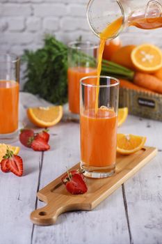 Detox drink. Freshly made Carrot Strawberry Orange Juice. For those who monitor their health