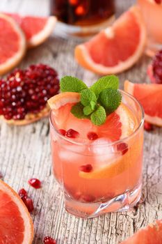 Tequila cocktail with pomegranate and grapefruit juice, tinted with the aroma of a fresh sprig of mint