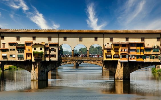 Crowd of tourists in the central loggia of Ponte Vecchio on the Arno river in Florence. Tourism and travel. Italian tourist attraction