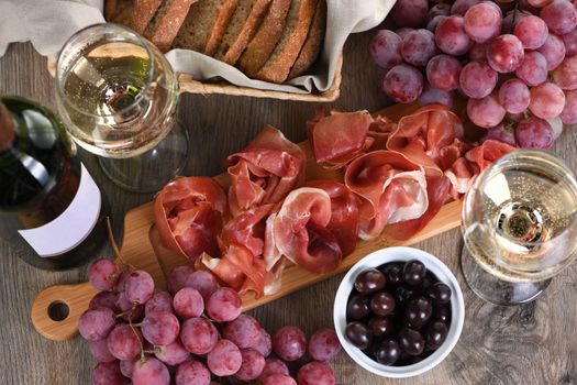 Antipasto. Wine set   snack sun-dried ham  jamon with grapes and olives