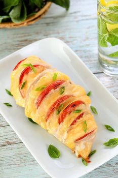 Chicken caprese. Tender chicken breast baked with slices of tomato and cheese.