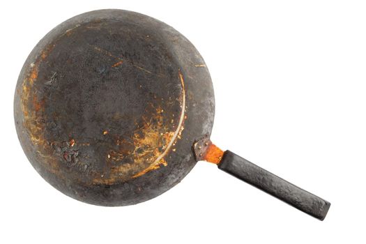 old stained rusty cast iron pan with burnt fat isolated on white bottom up in flat lay perspective.
