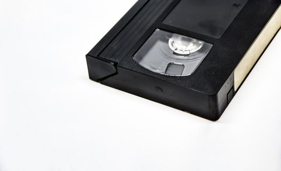 Close-up view of a VHS format videotape. VHS is a standard analog video recording system on magnetic tape developed in the 70s and 80s and in use until the early 2000s. Home entertainment