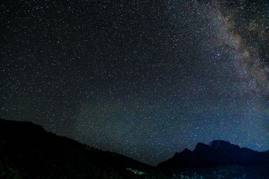 Starry sky and the Milky Way with bright stars over the mountains of North Ossetia.