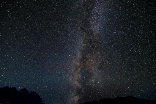 Starry sky and the Milky Way with bright stars over the mountains of North Ossetia.