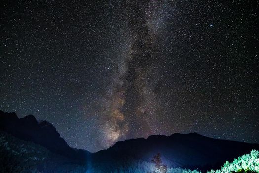 Starry sky and the Milky Way with bright stars over the mountains of North Ossetia.