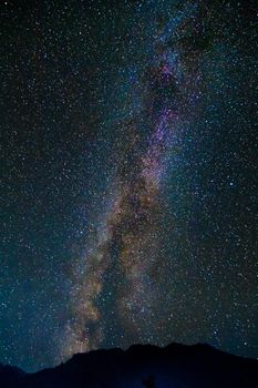 Starry sky and the Milky Way with bright stars over the mountains of North Ossetia.