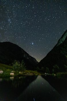 Starry sky and the Milky Way with bright stars over the mountains of North Ossetia.