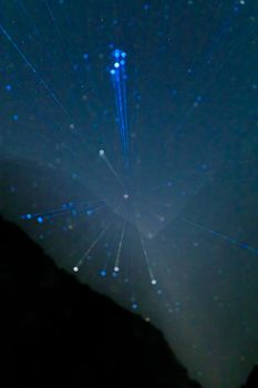 Starry sky and the Milky Way with bright stars over the mountains of North Ossetia.