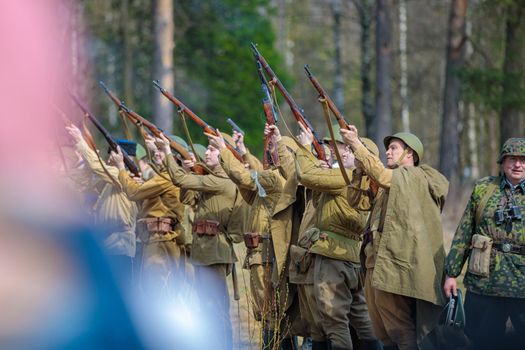 Reconstruction of the Second World War. Russian soldiers celebrate the victory, a volley of rifles upwards. The Great Patriotic War. Liberation of Odessa. Zelenograd Russia April 18, 2021