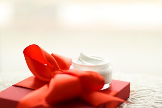 Beauty, cosmetics and skincare styled concept - Luxury face cream jar and red gift box