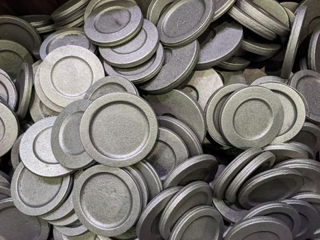 full frame pile of gray steel forgings after shot blasting - close-up natural heavy industrial pattern with selective focus.