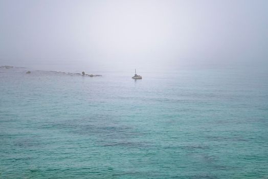 A large body of water on a foggy morning in Jaffa port, Tel Aviv, Israel. High quality photo