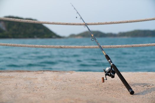 A fishing rod with sea background, fishing.