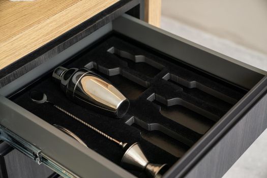 Bartender tools in wooden boxes. shaker and tableware in the drawer. Bartender equipment.