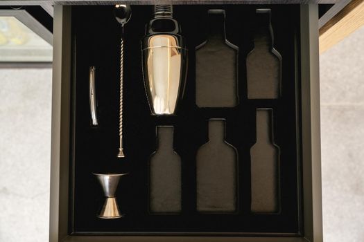 Bartender tools in wooden boxes. shaker and tableware in the drawer. Bartender equipment.