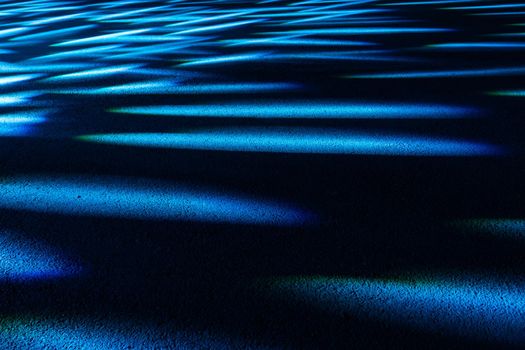 Dramatic multicolored lights on the floor in a disco, stage light show.