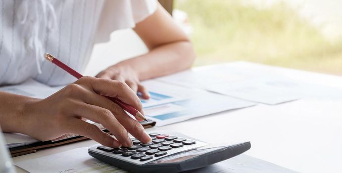 Business woman or accountant working in finance and accounting Analyze financial budget - work from home concept.