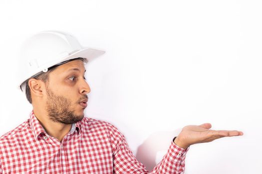 Handsome builder worker with white helmet showing his hands