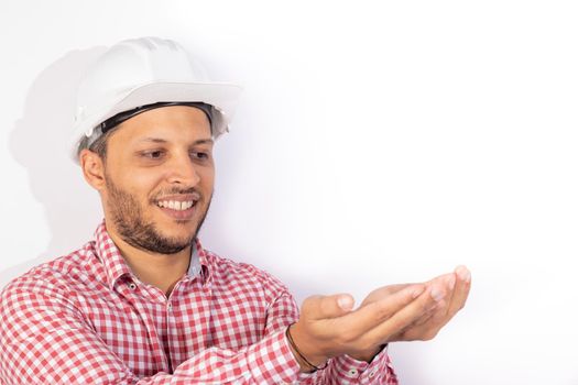 Handsome builder worker with white helmet showing his hands