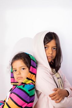 Portrait of little sisters wearing hooded sweater