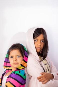 Portrait of little sisters wearing hooded sweater