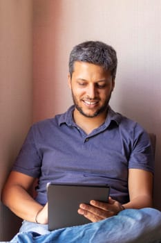 Handsome man working at home with his tablet