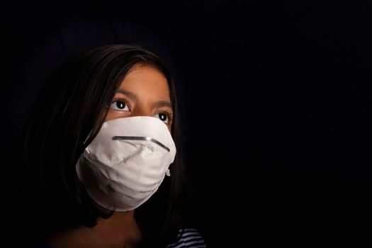 Portrait of little girl wearing a medical mask used for virus protection